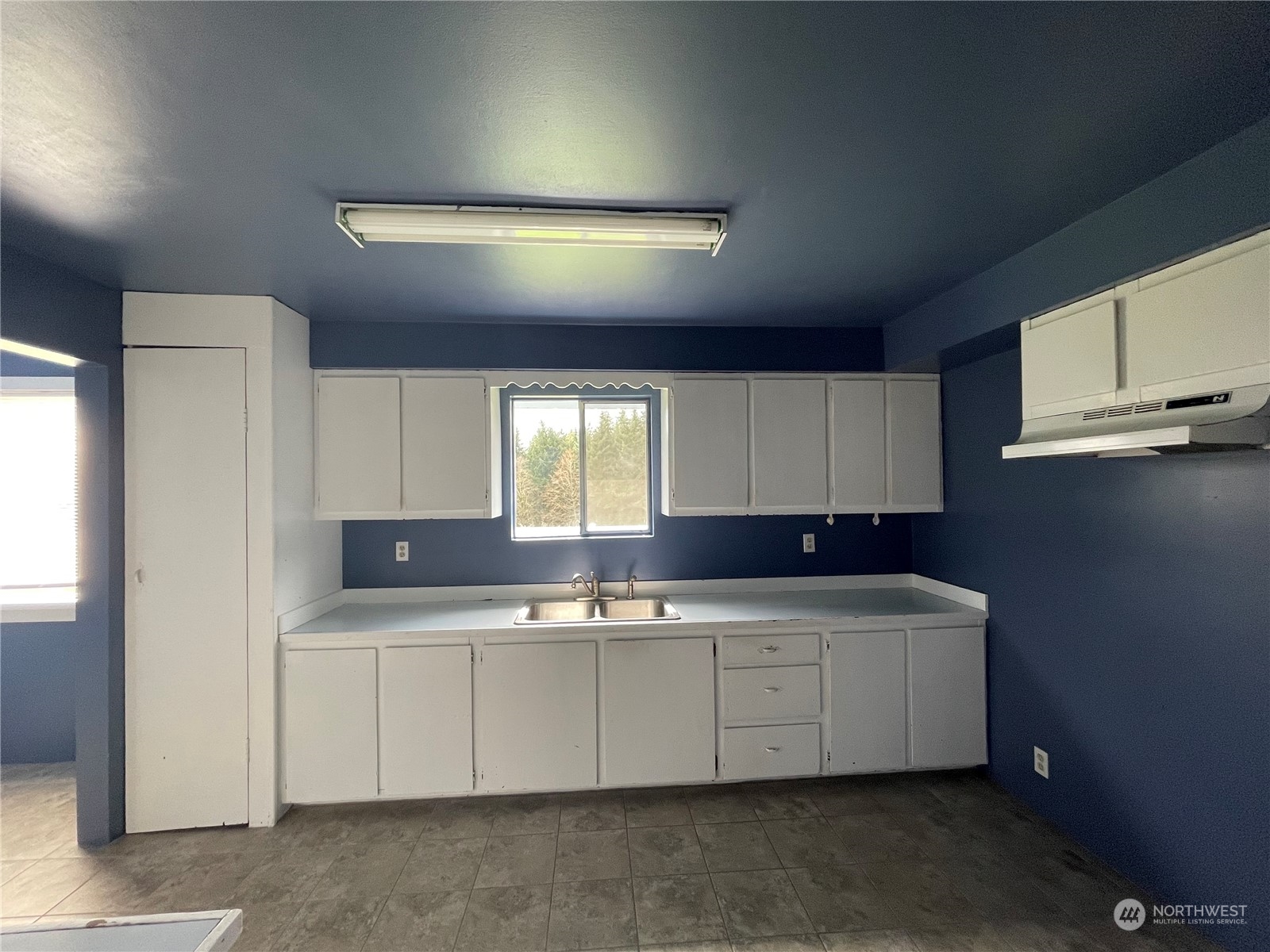 1313 Stella Road Longview, WA 98632 - Photo 14 of 20 a kitchen with a sink a cabinets and window