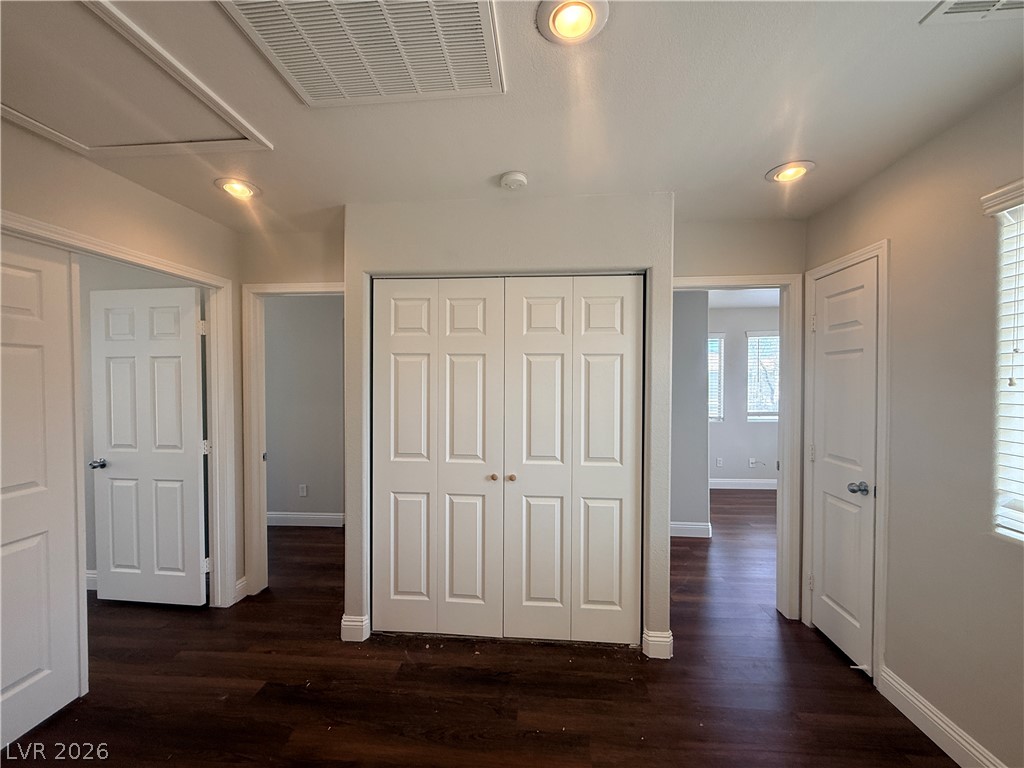 11953 Fairfax Ridge Street Las Vegas, NV 89183 - Photo 29 of 32 Rich hardwood floors flow through this hallway with ample closet space.