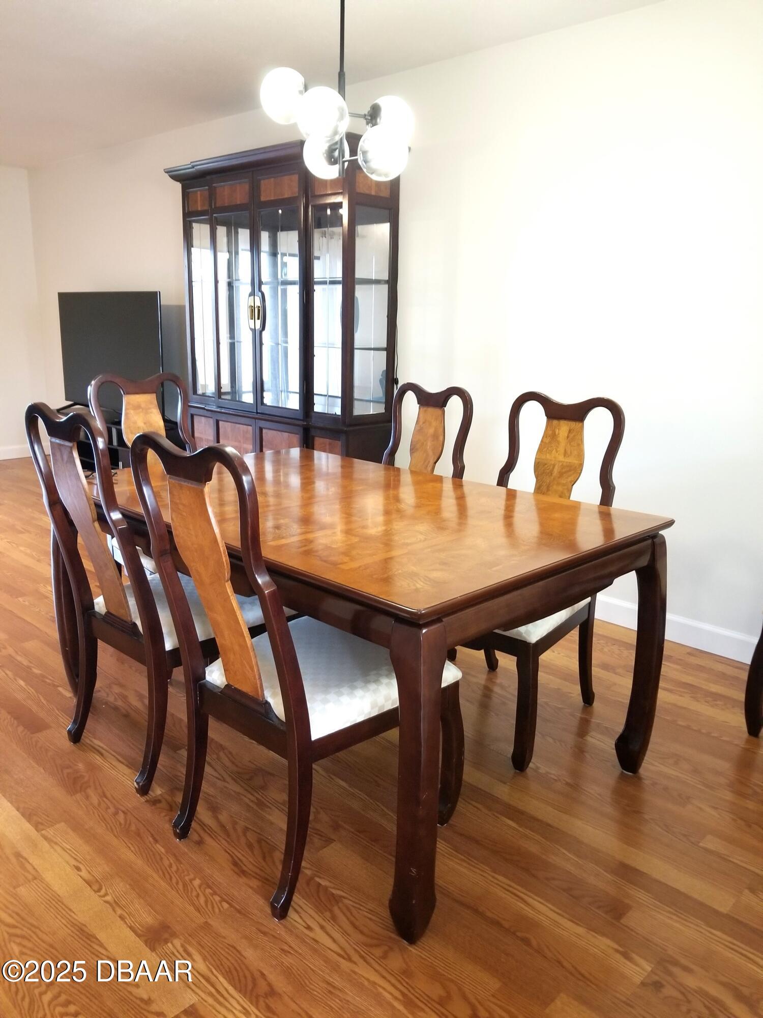 165 White Fawn Drive, Unit MB Daytona Beach, FL 32114 - Photo 11 of 34 a view of a dining room with furniture window and wooden floor