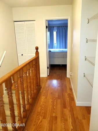 a view of a hallway and wooden floor