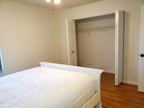 a view of empty room with wooden floor