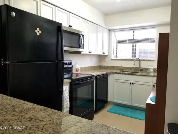 a kitchen with a refrigerator and a sink