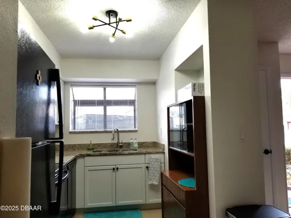 a kitchen with a refrigerator and a sink