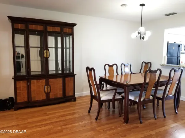 a view of a dining room with furniture window and wooden floor