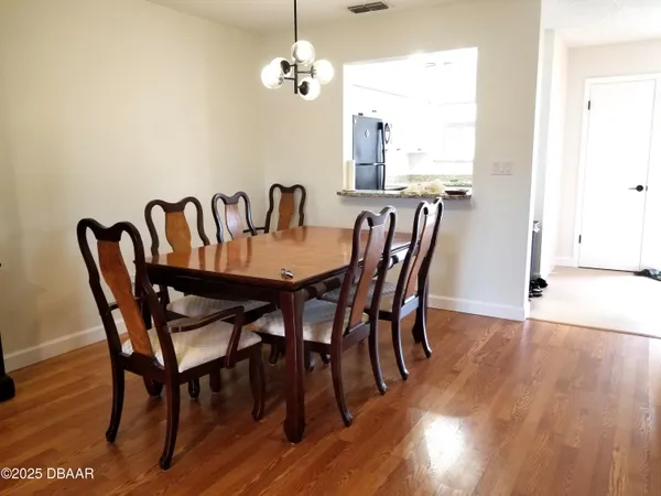 a view of a dining room with furniture window and wooden floor