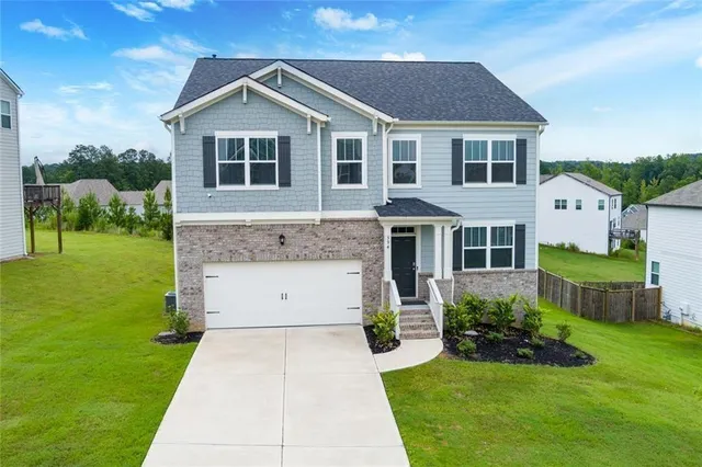 a front view of a house with a yard
