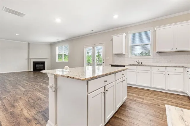 a kitchen with granite countertop a sink and cabinets