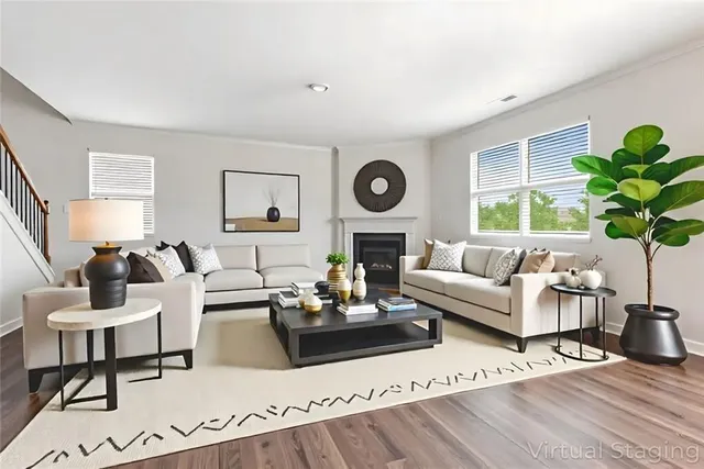 a living room with furniture a clock on wall and a window
