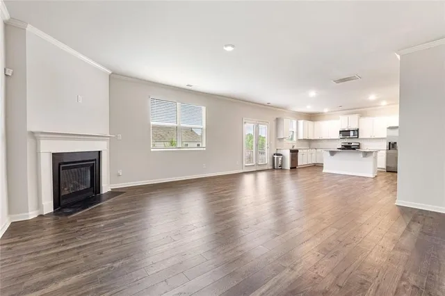 a view of a living room a kitchen with furniture and a fireplace