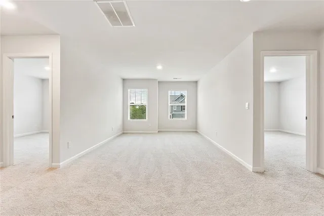 an empty room with windows and entrance