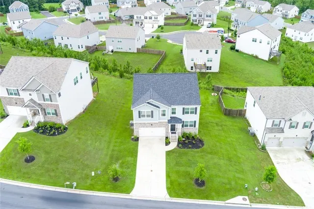 an aerial view of residential houses with outdoor space and street view