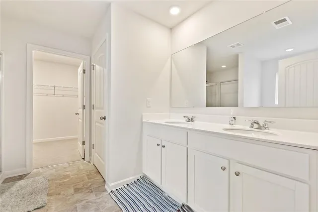 a bathroom with a double vanity sink mirror and