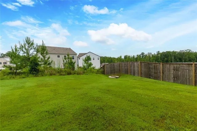 a view of yard with swimming pool and green space