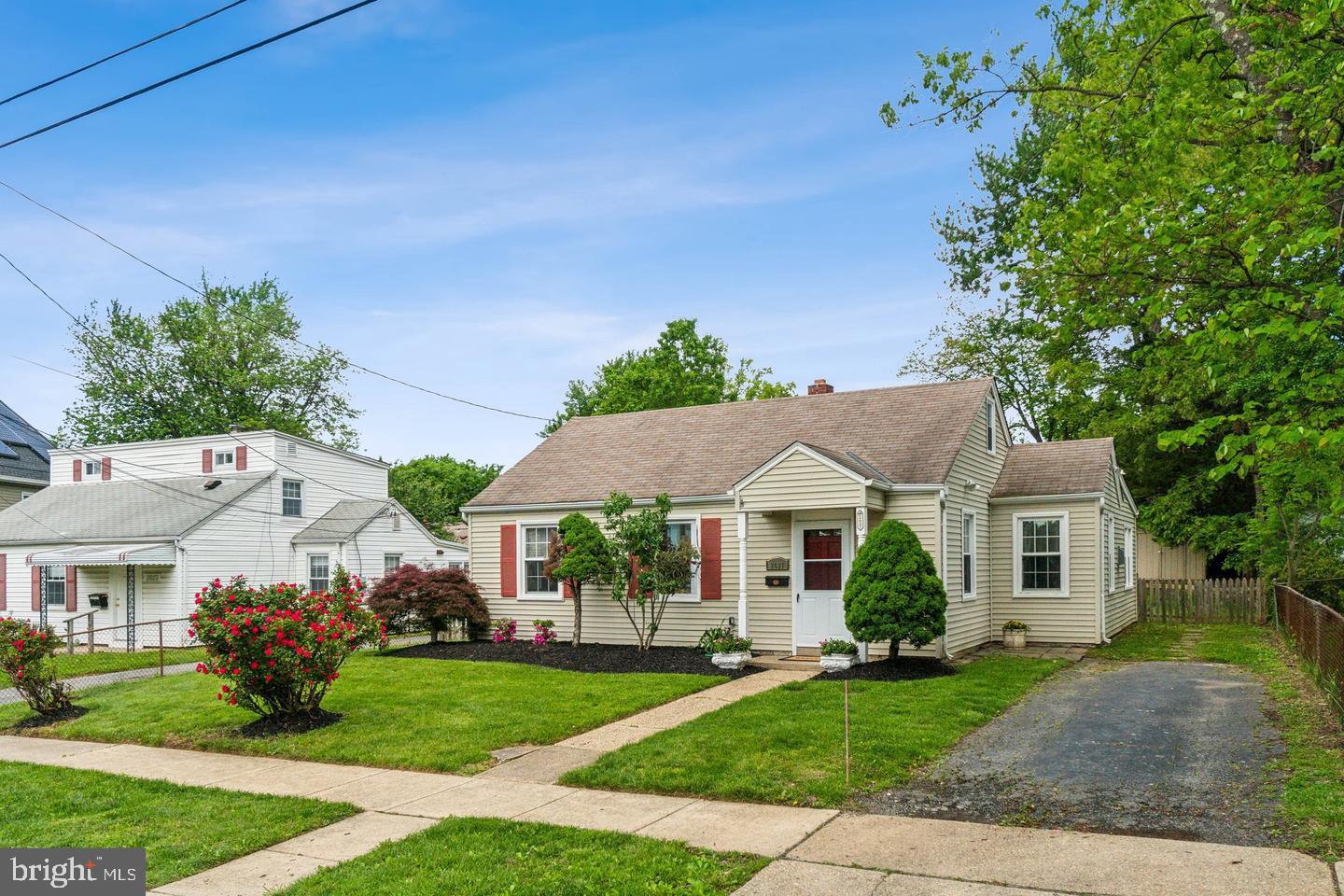 2621 Terrapin Road Silver Spring, MD 20906 - Photo 4 of 11 a view of a white house with a yard and potted plants