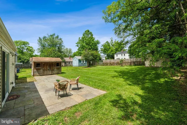 a view of a patio with table and chairs potted plants with sky view