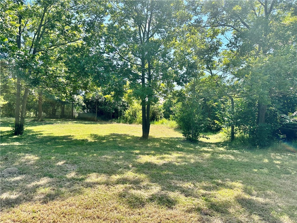 1009 South 18th Street Temple, TX 76501 - Photo 2 of 8 a view of swimming pool with a big yard and large trees