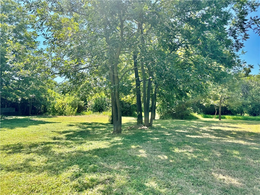 1009 South 18th Street Temple, TX 76501 - Photo 8 of 8 a big yard with lots of green space and trees in the back