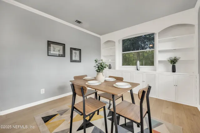 a view of a dining room with furniture and window