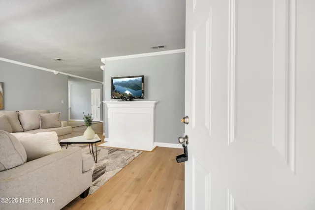 a living room with furniture and a wooden floor