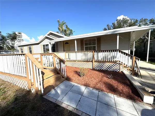 a view of a house with a wooden deck