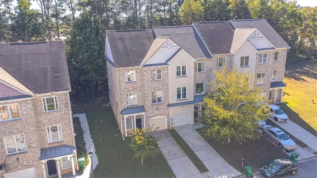 a aerial view of a house with a yard and potted plants