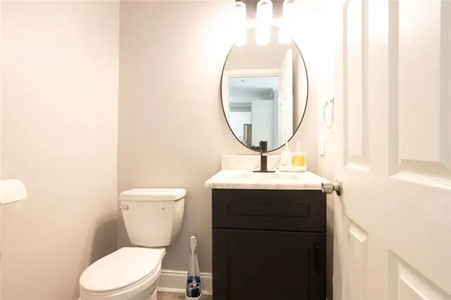 a bathroom with a toilet a sink and a mirror