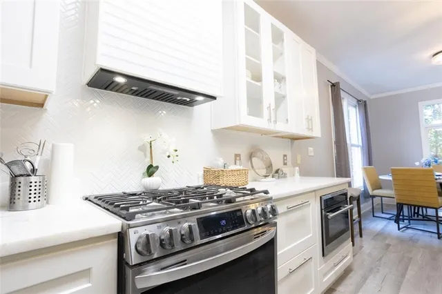 a stove top oven sitting inside of a kitchen