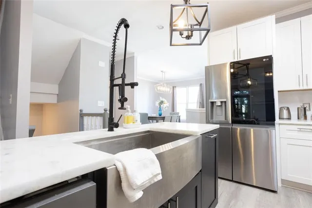 a kitchen with a sink appliances and cabinets