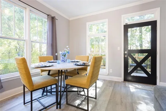 a view of a dining room with furniture and window