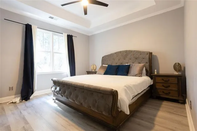 a bedroom with a bed and a large window