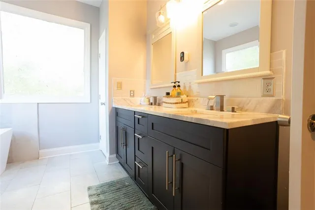 a bathroom with a double vanity sink and a mirror