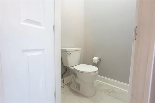a white toilet sitting next to a white sink