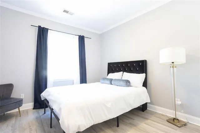 a bedroom with a bed and a lamp