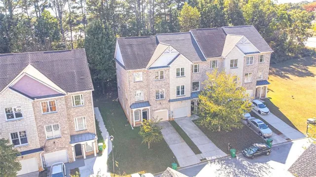a aerial view of a house with a yard and balcony