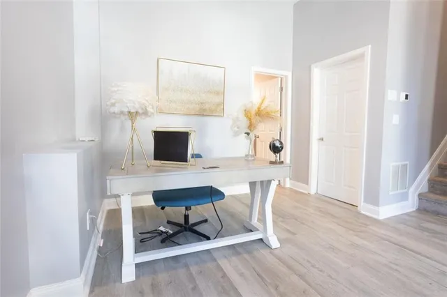 a workspace with wooden floor and a bathroom