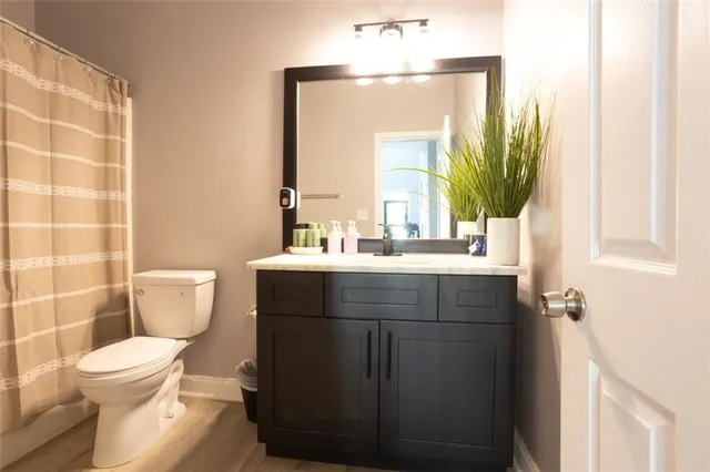 a bathroom with a sink toilet and mirror