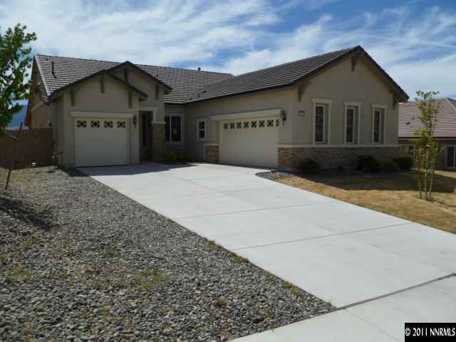 10185 Cavalry Circle Reno, NV 89521 - Photo 2 of 13 a front view of a house with a yard and garage