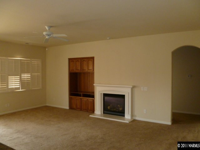 10185 Cavalry Circle Reno, NV 89521 - Photo 3 of 13 a view of an empty room with a fireplace and a window