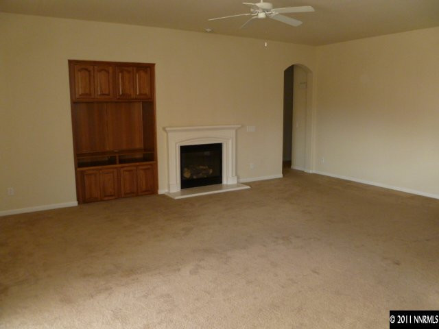 10185 Cavalry Circle Reno, NV 89521 - Photo 4 of 13 an empty room with a fireplace