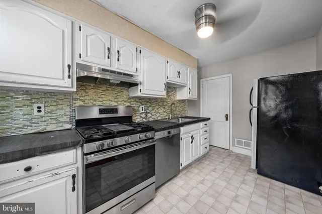 a kitchen with stainless steel appliances granite countertop a stove a refrigerator and a granite counter tops