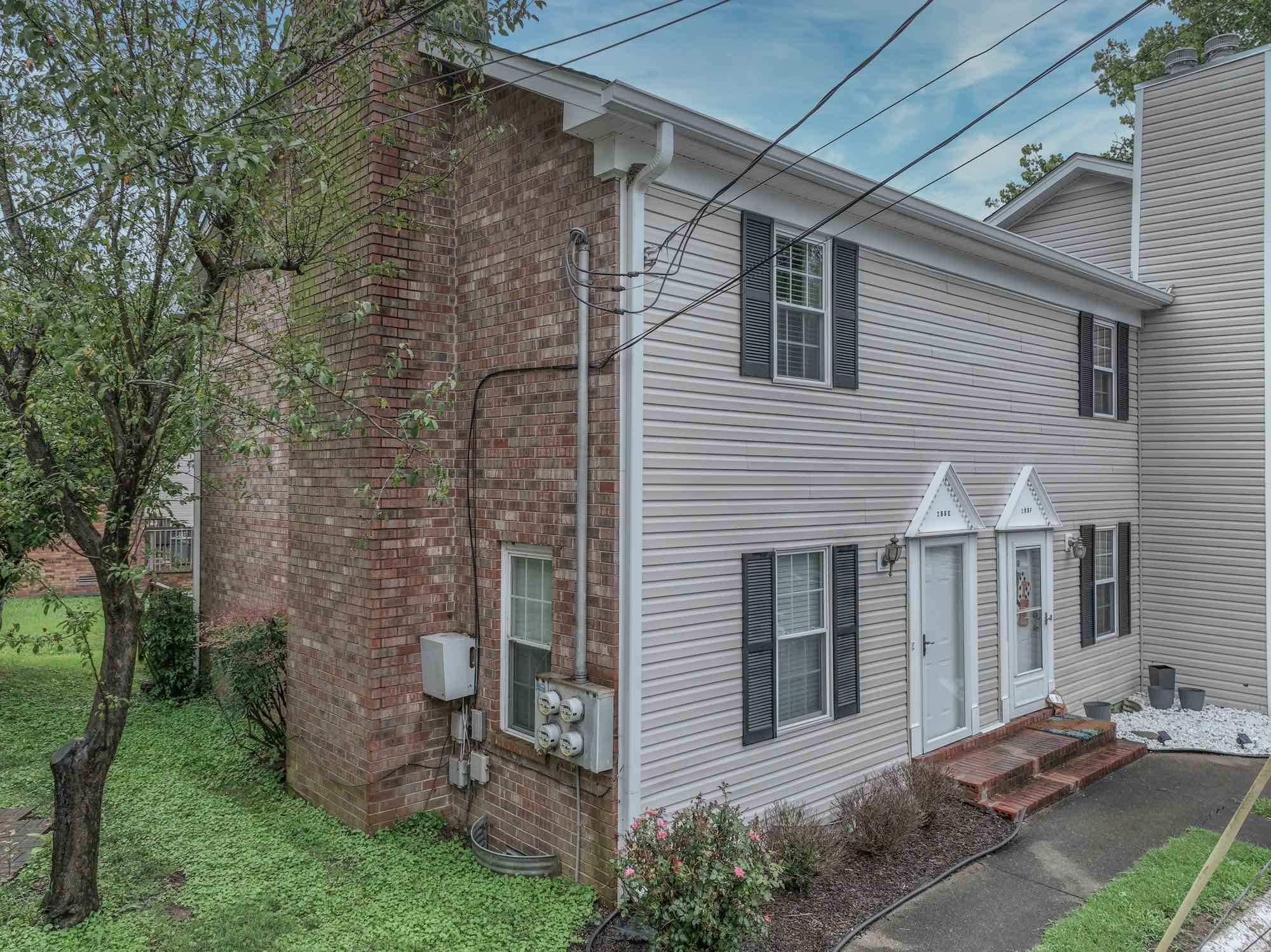 288 Donna Drive, Unit E Hendersonville, TN 37075 - Photo 3 of 23 a view of a brick house with a yard