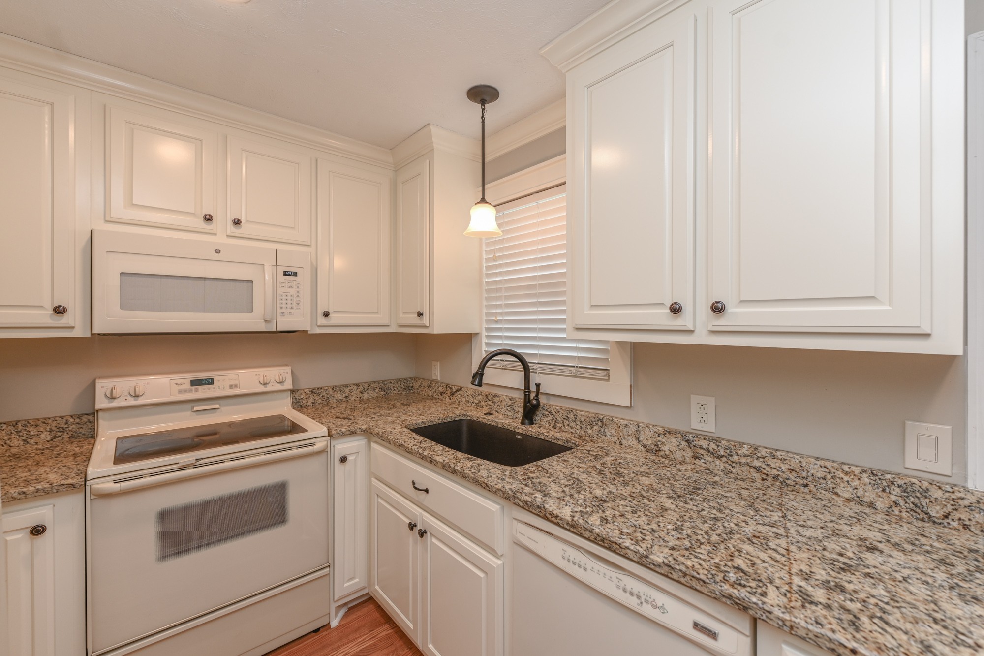 288 Donna Drive, Unit E Hendersonville, TN 37075 - Photo 7 of 23 a kitchen with granite countertop white cabinets and white appliances