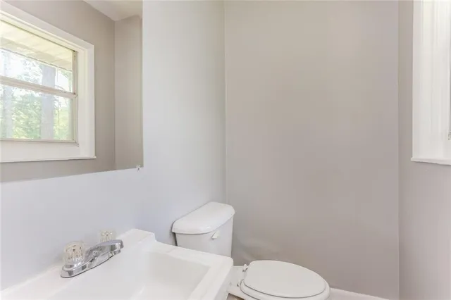 a white toilet sitting next to a bathroom sink