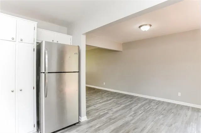 a view of a refrigerator in kitchen and wooden floor