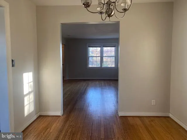a view of a room with wooden floor and a window