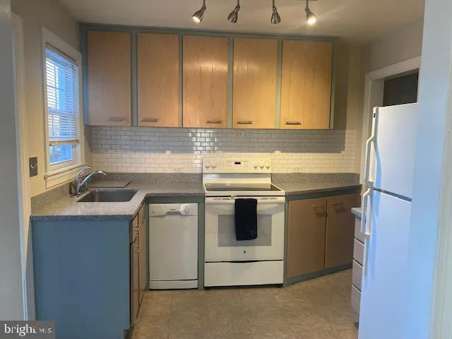 a kitchen that has a sink a stove and window