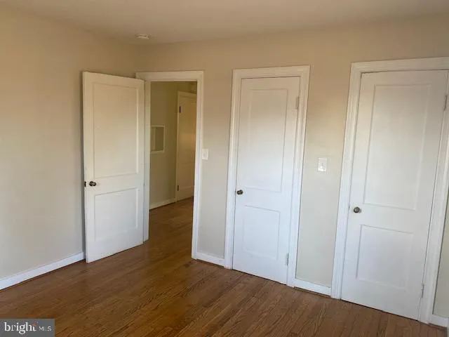 a view of a room with wooden floor and chandelier