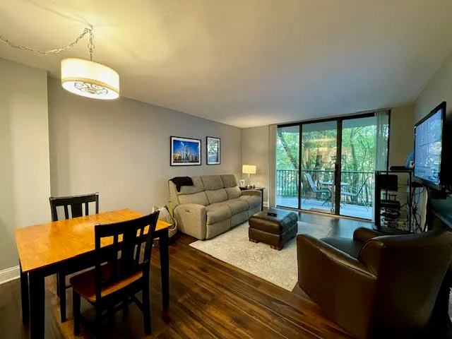a living room with furniture and a floor to ceiling window
