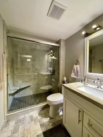 a bathroom with a sink toilet and shower