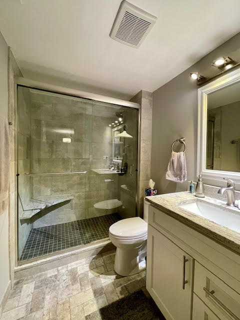 509 Aurora Avenue, Unit 308 Naperville, IL 60540 - Photo 8 of 22 a bathroom with a sink toilet and shower